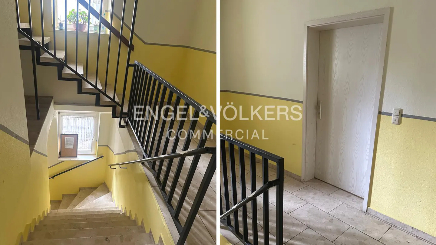Stairwell with yellow walls, black railings, and beige stairs. A white door is on the right. The Engel & Völkers logo is visible.