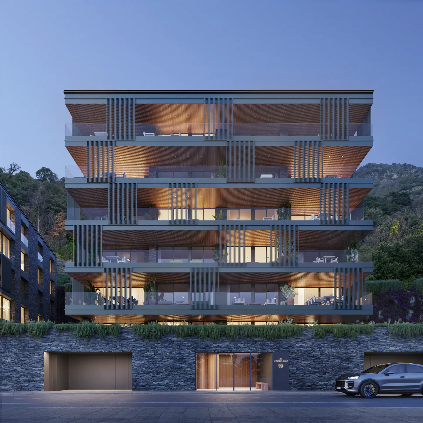 Modern five-story apartment building with wooden balconies, stone base, and warm interior lighting at dusk.