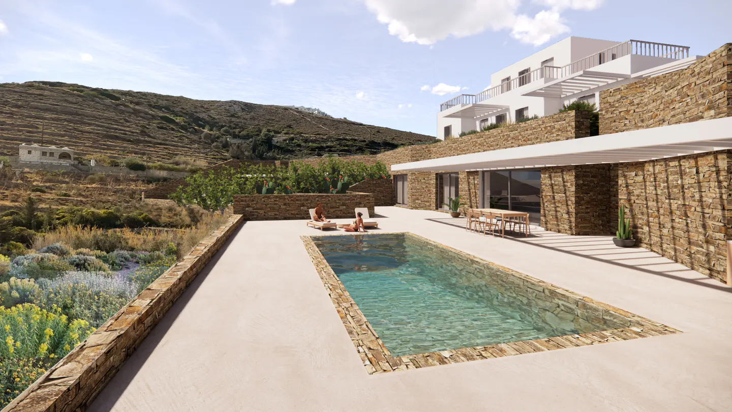 Modern stone house with a pool. Two people are sunbathing on lounge chairs. A mountain is in the background.