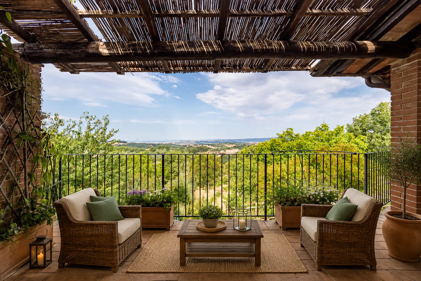 Outdoor patio with wicker furniture, a wooden table, and a view of rolling hills under a blue sky.