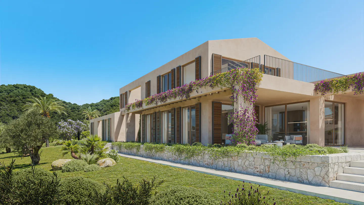 Two-story beige house with brown shutters, a balcony, and purple flowers. Green lawn and trees surround the house. Blue sky.