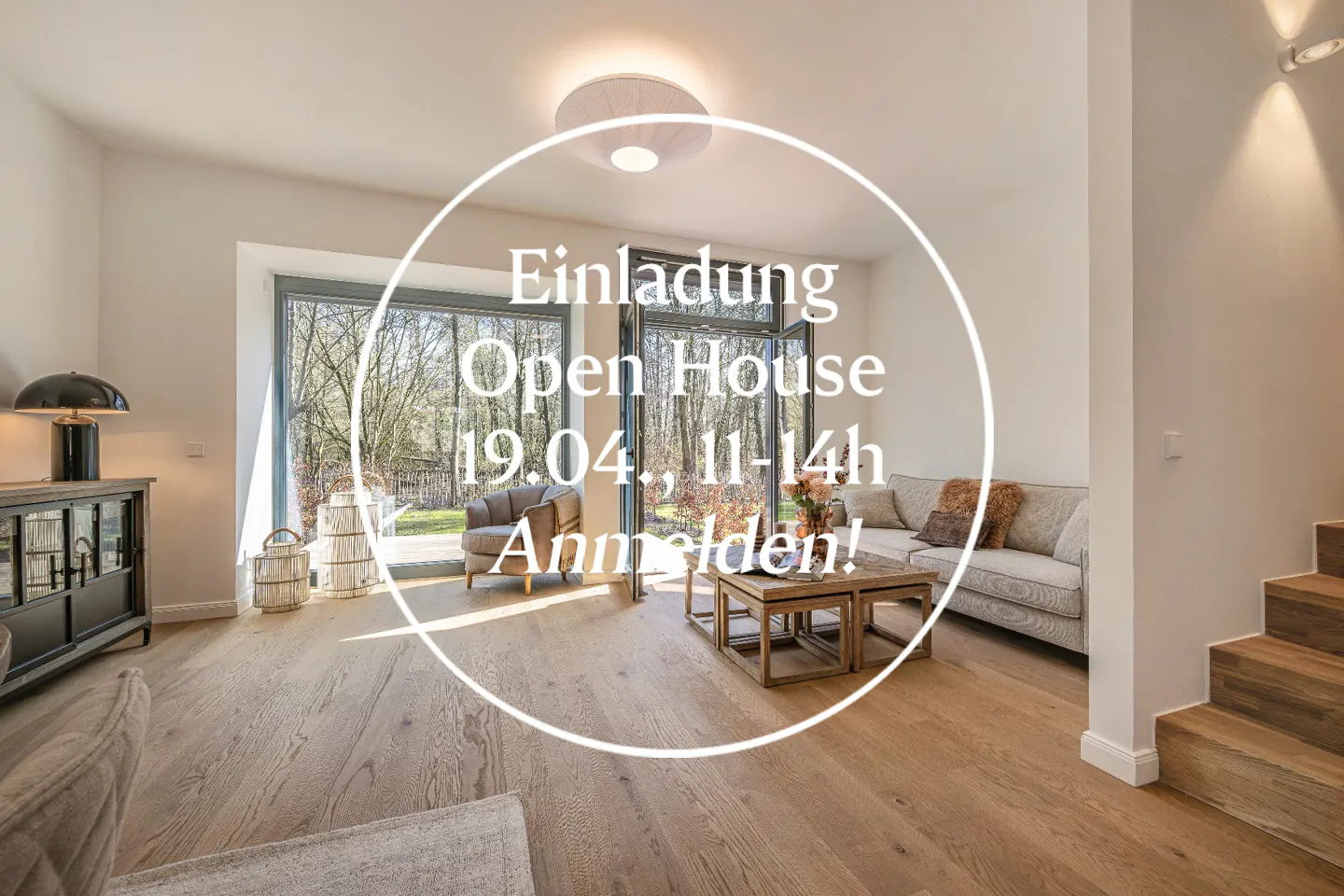 Bright living room with hardwood floors, sofa, chair, and coffee table. Large windows overlook trees. Text overlay advertises an open house.