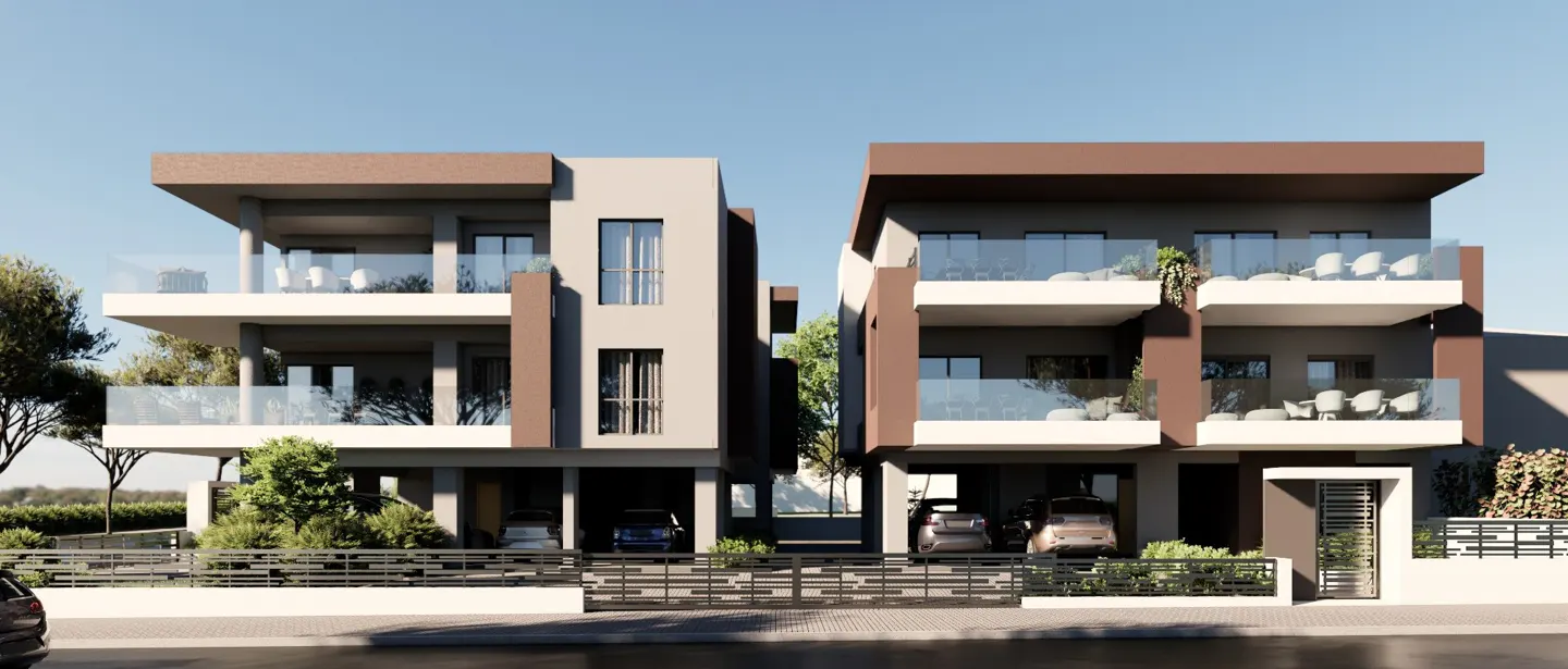 Modern two-story townhouses with brown and beige exteriors, glass balconies, and carports, set against a clear blue sky.