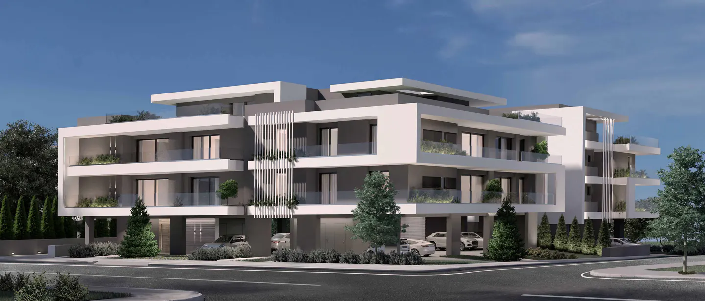 Modern three-story apartment building with white and gray facade, glass balconies, and ground-level parking.