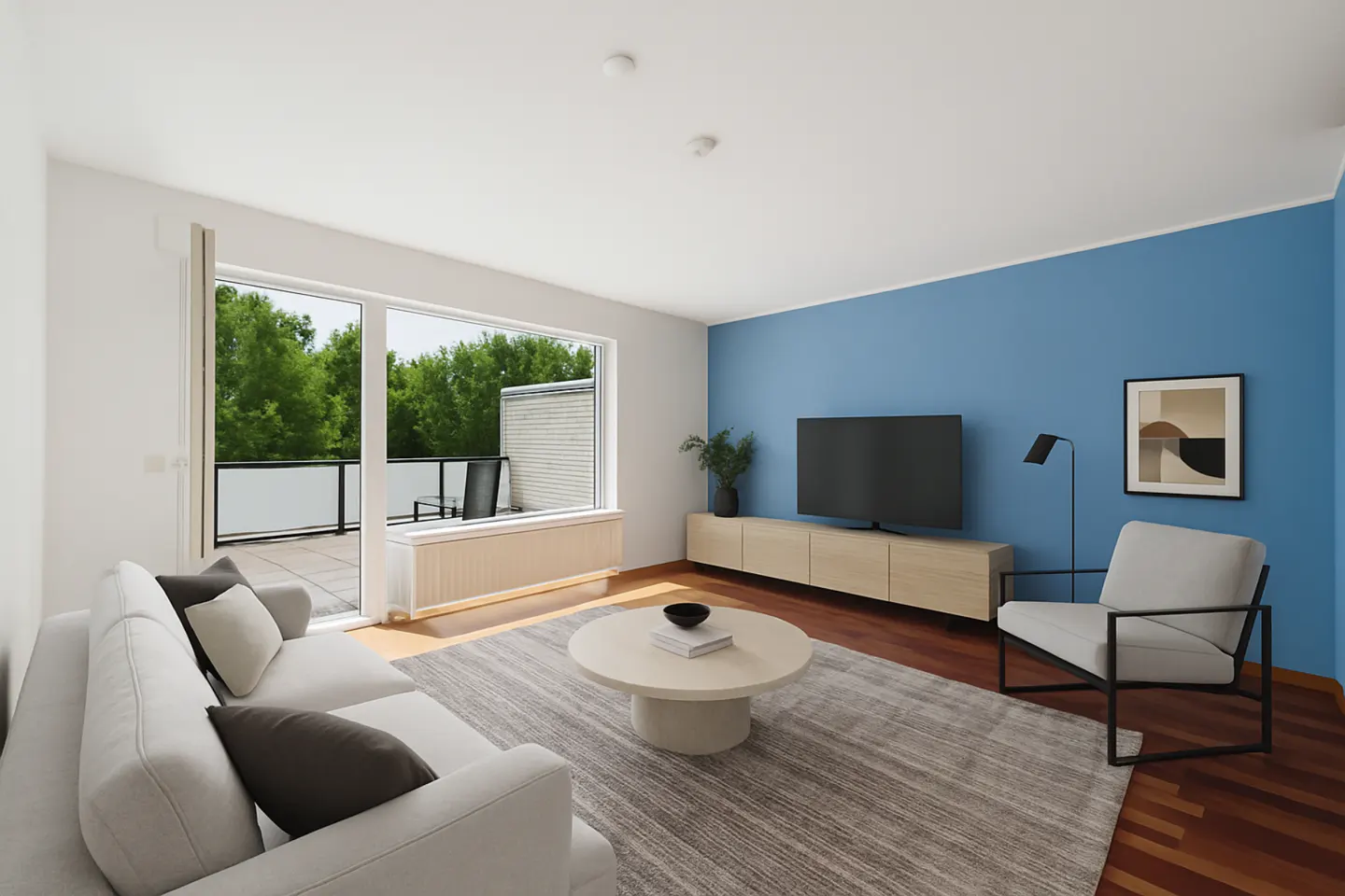 Bright living room with white sofa, round table, and blue accent wall. Balcony visible through sliding glass doors.