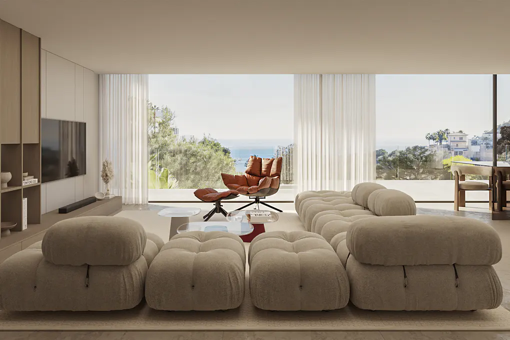Living room with a beige sectional sofa, brown leather chair, and ocean view through large windows.