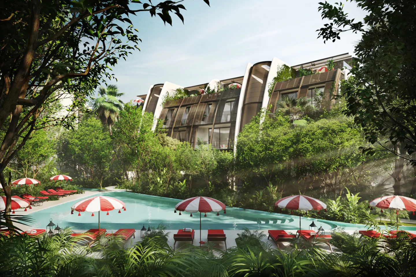 Poolside view of a modern building with red and white umbrellas and lounge chairs surrounded by lush greenery.