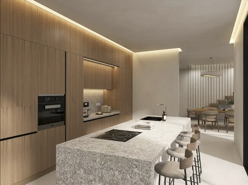 Modern kitchen with wood cabinets, speckled stone island with stools, and dining area in the background.