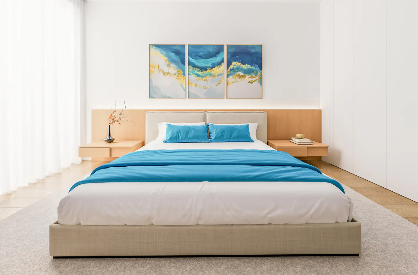 Modern bedroom with a beige bed frame, white bedding, and a blue throw blanket. Three blue and gold abstract paintings hang above the headboard.