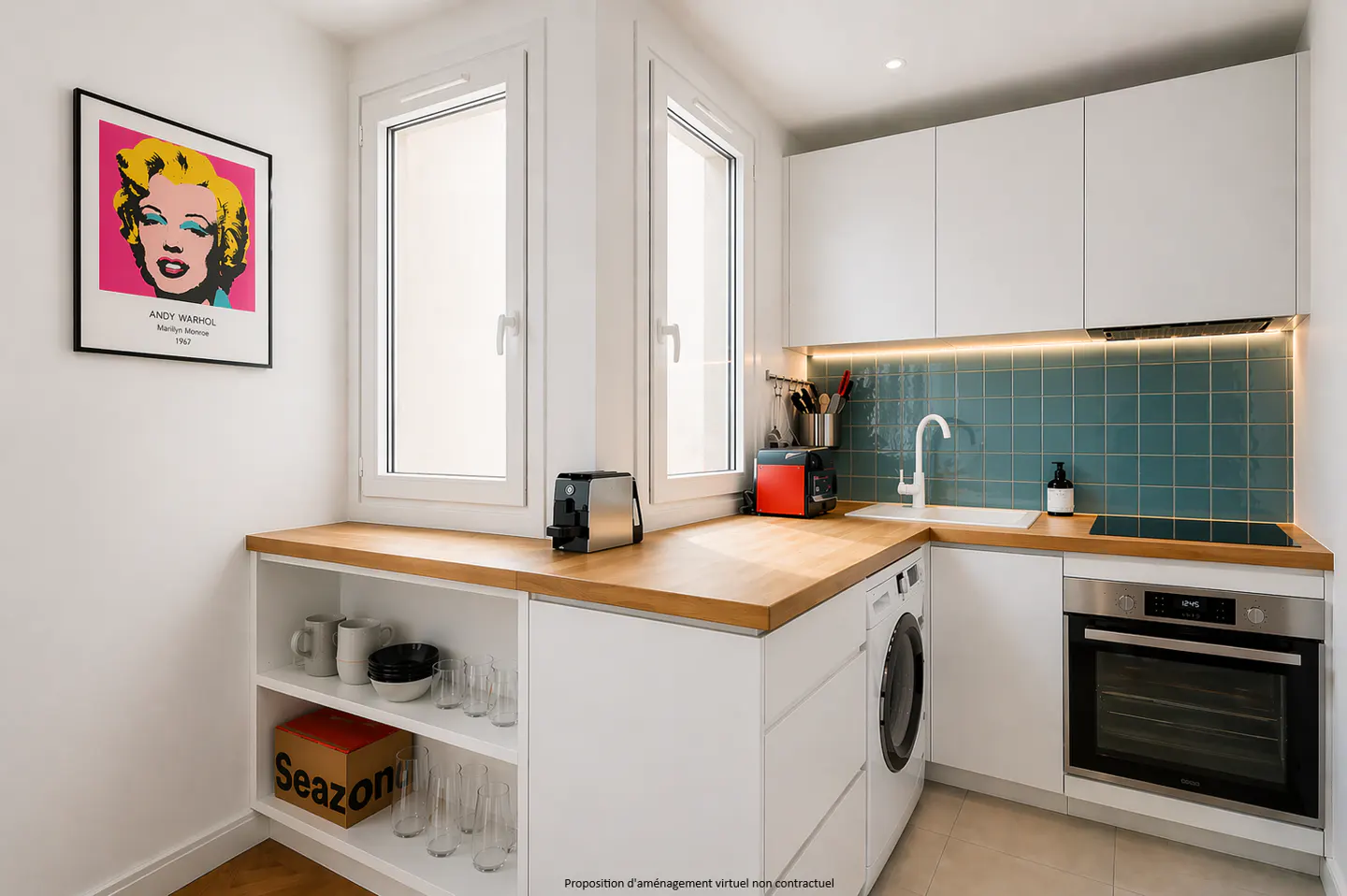 Bright, modern kitchen with white cabinets, wood countertop, and teal tile backsplash. Andy Warhol print on the wall.