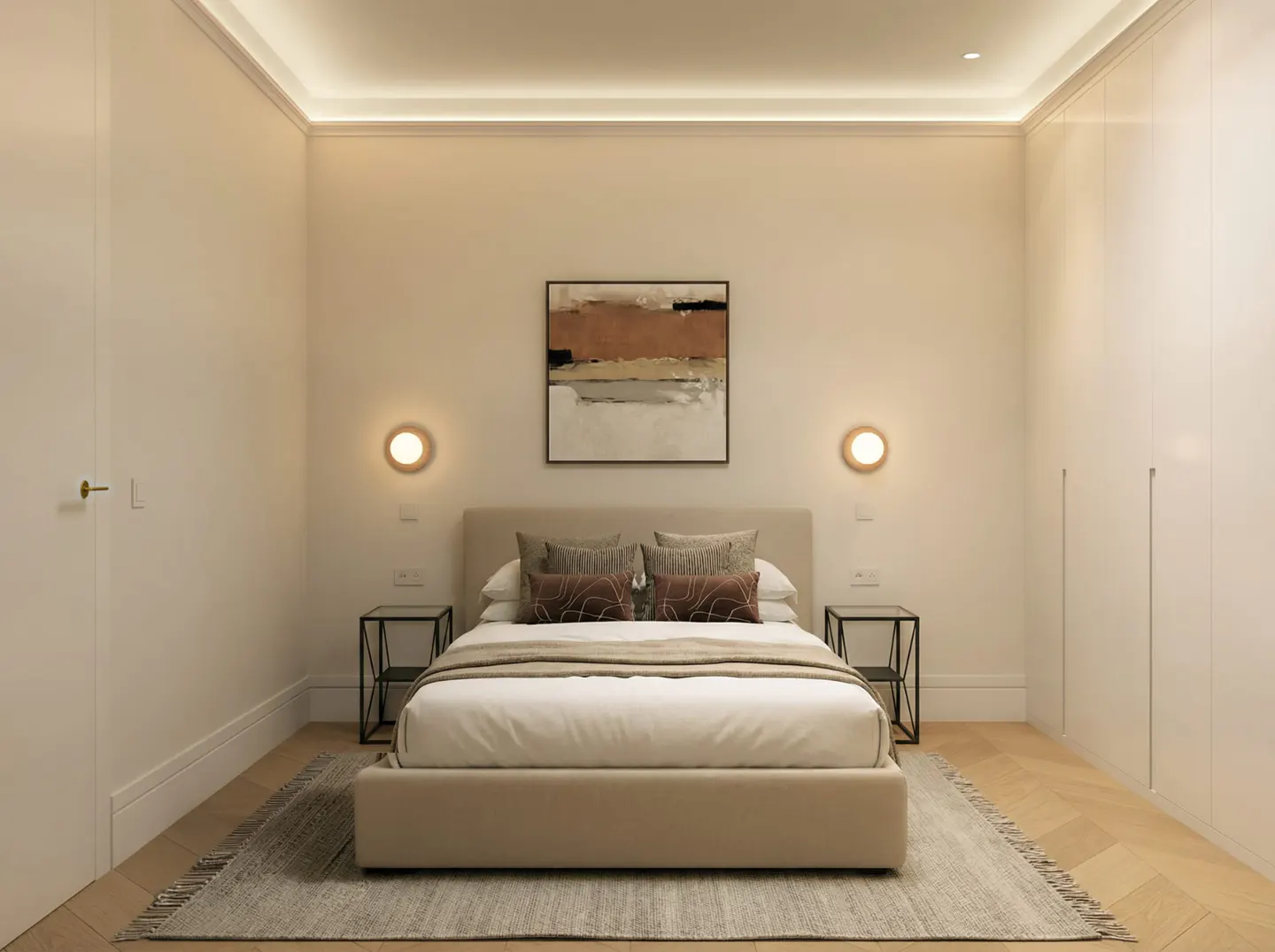 Bedroom with a beige bed, white walls, and wood floors. Abstract art hangs above the bed, flanked by sconces. Nightstands sit on either side.