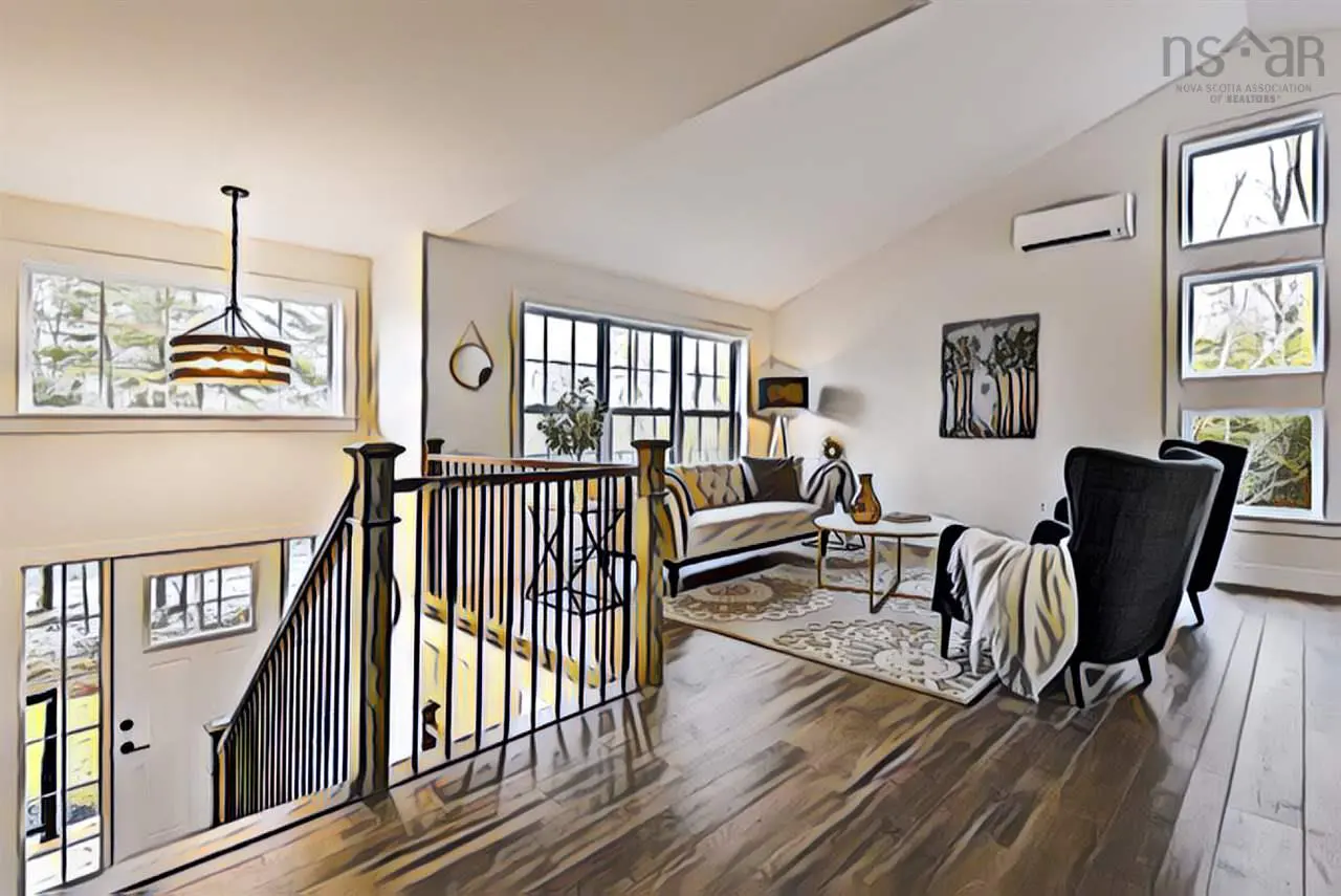 Bright living room with hardwood floors, a white sofa, black chairs, and a staircase with black railings. Large windows provide natural light.