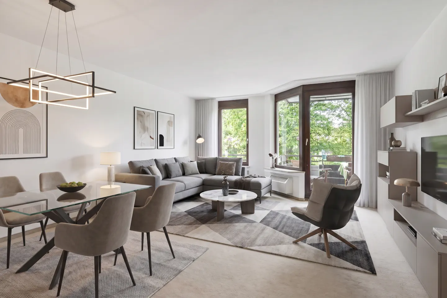 Bright living and dining area with gray sectional, glass table, and modern light fixture. Large windows overlook green trees.