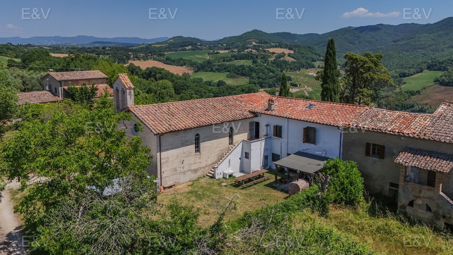 Portion of farmhouse nestled in the green hills of the Upper Tiber Valley