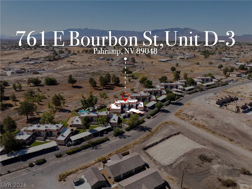 Aerial view of 761 E Bourbon St, Unit D-3, Pahrump, NV 89048. Tan buildings with red roofs, desert landscape, and mountains in the distance.
