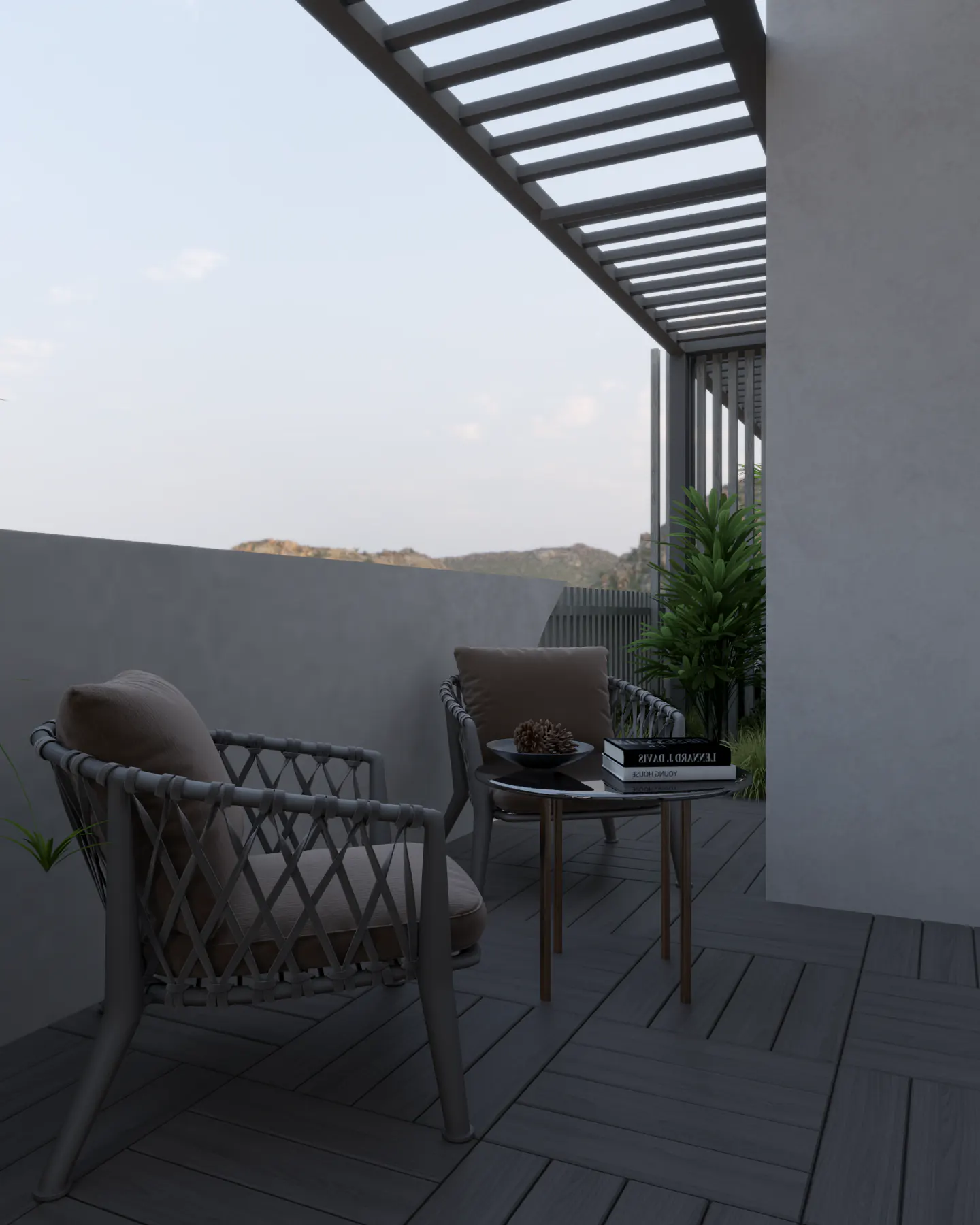 Outdoor patio with two gray woven chairs, a small table with books, and a pergola overhead. Hills are visible in the background.