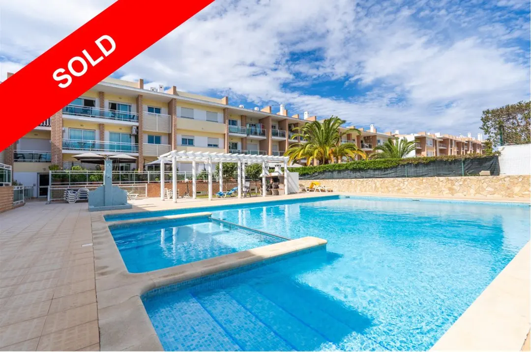 A "SOLD" banner overlays an image of a multi-story apartment complex with a blue swimming pool in the foreground.