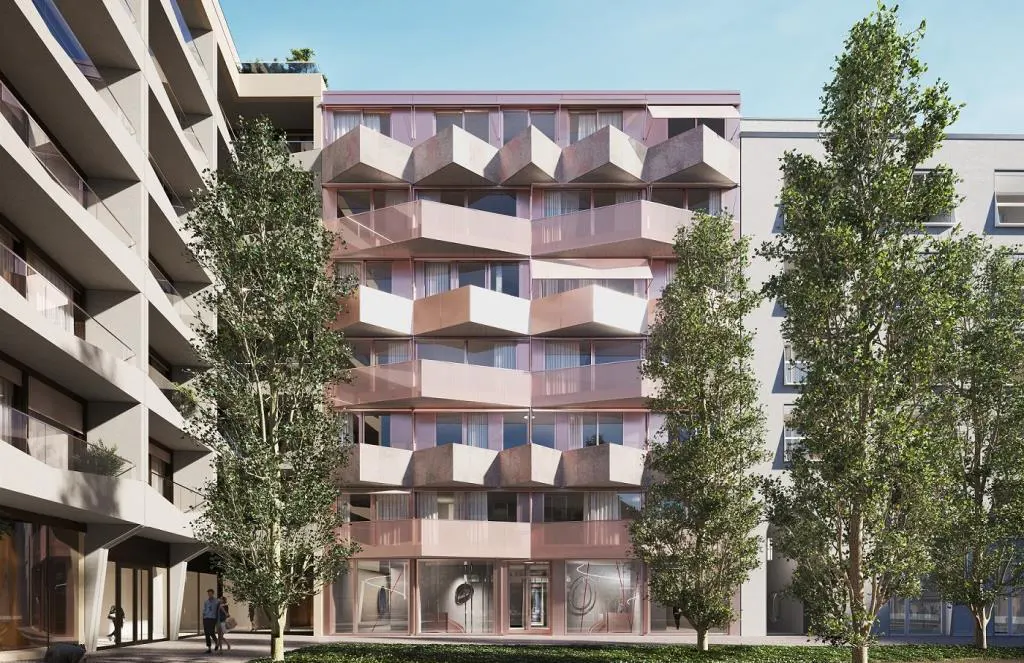 Modern apartment building with geometric balconies, framed by trees. The building has a pinkish hue and large windows.