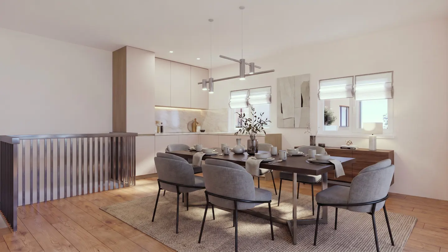 A bright, modern dining area with a dark wood table, gray upholstered chairs, and a light beige rug. The kitchen is in the background with white cabinets.