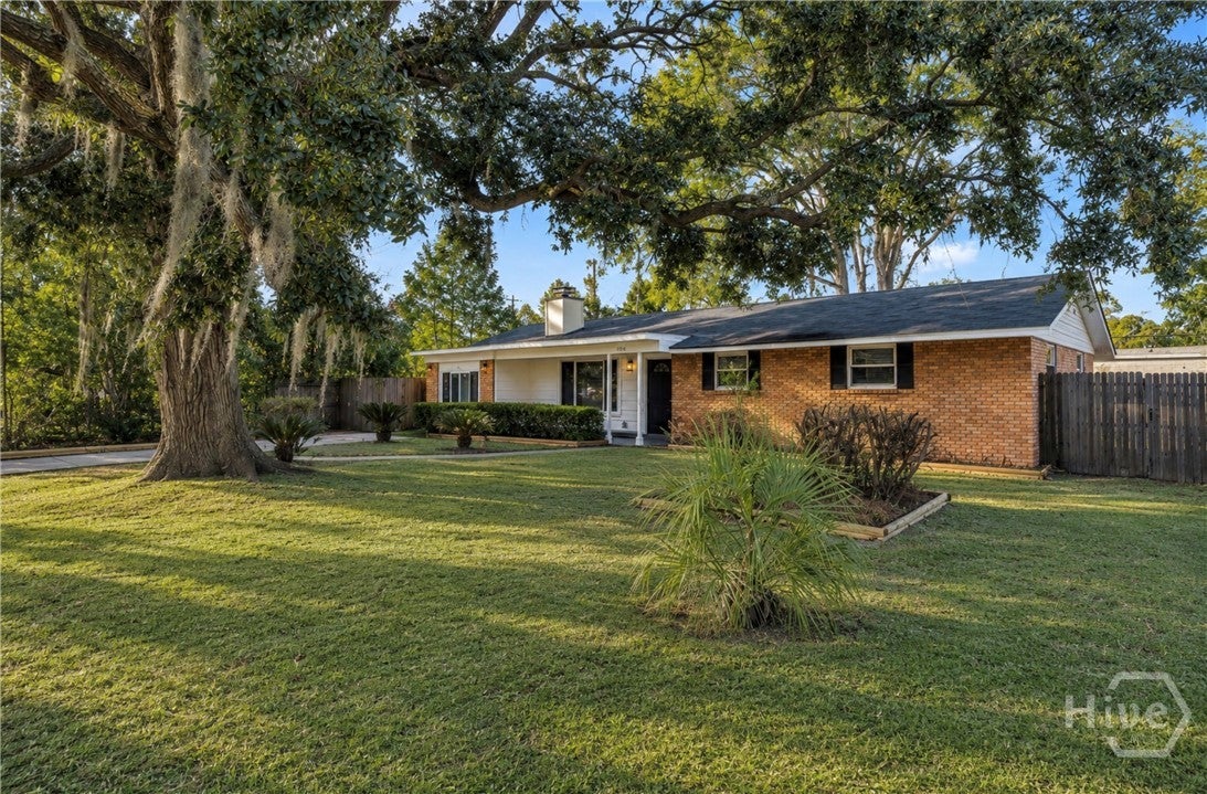 Hardwood Floors, Sunroom & a Backyard Made for Entertaining
