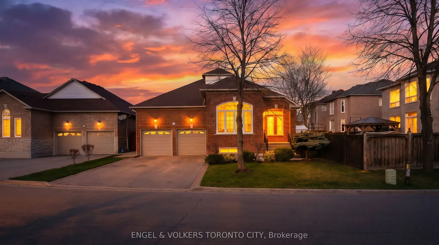 A brick house with a two-car garage at dusk, with a colorful orange and purple sky.