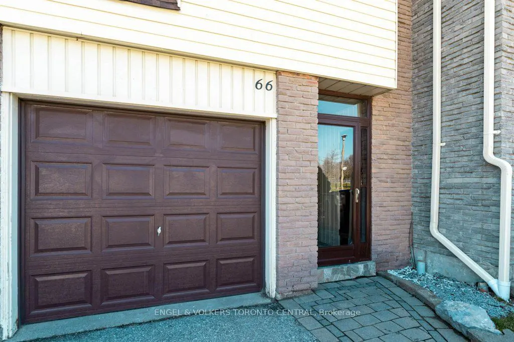 Exterior view of a house with a brown garage door, a brown front door, and the number 66 above the front door.