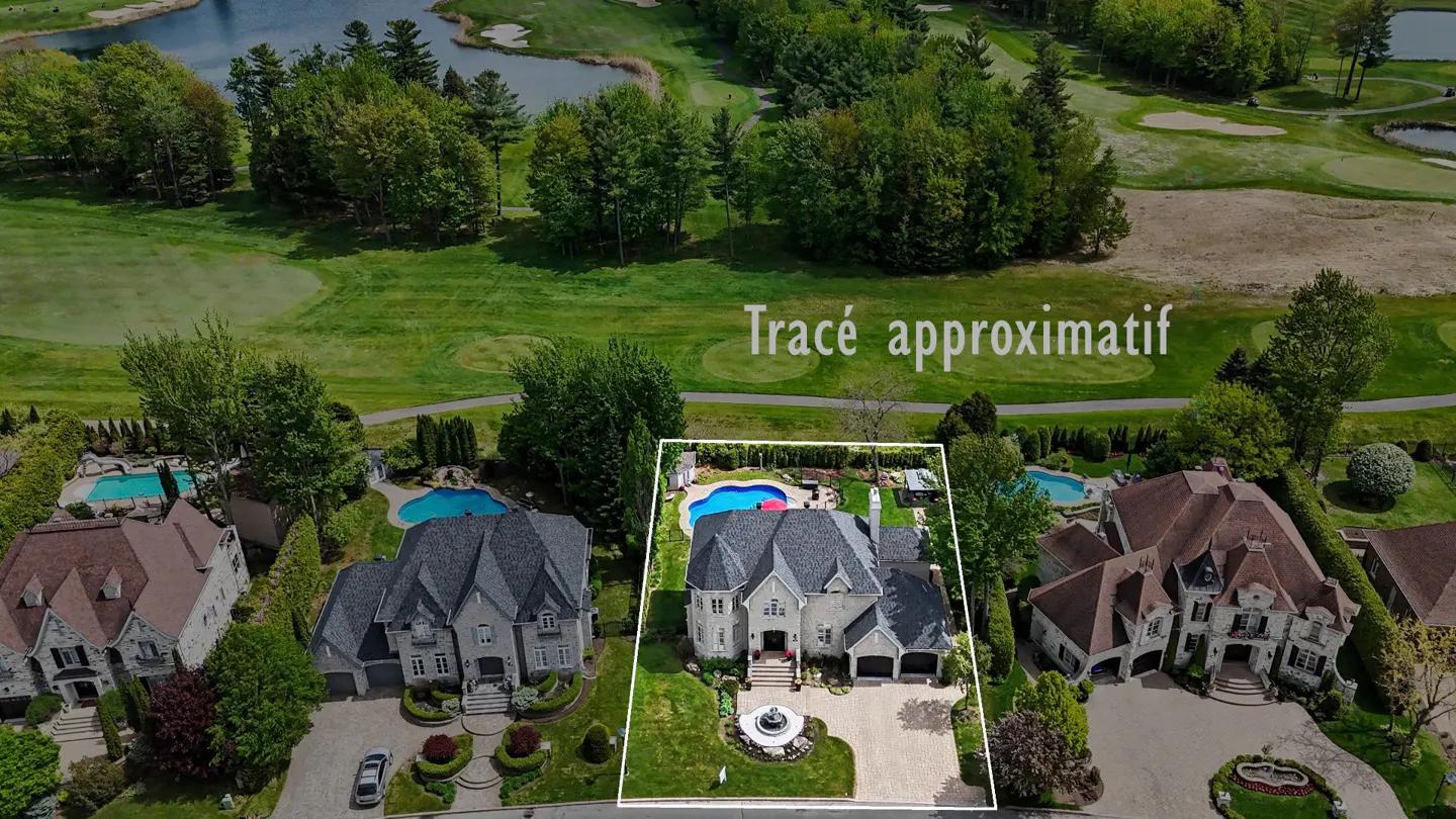 Aerial view of a large, grey stone house with a pool, outlined in white, next to a golf course.