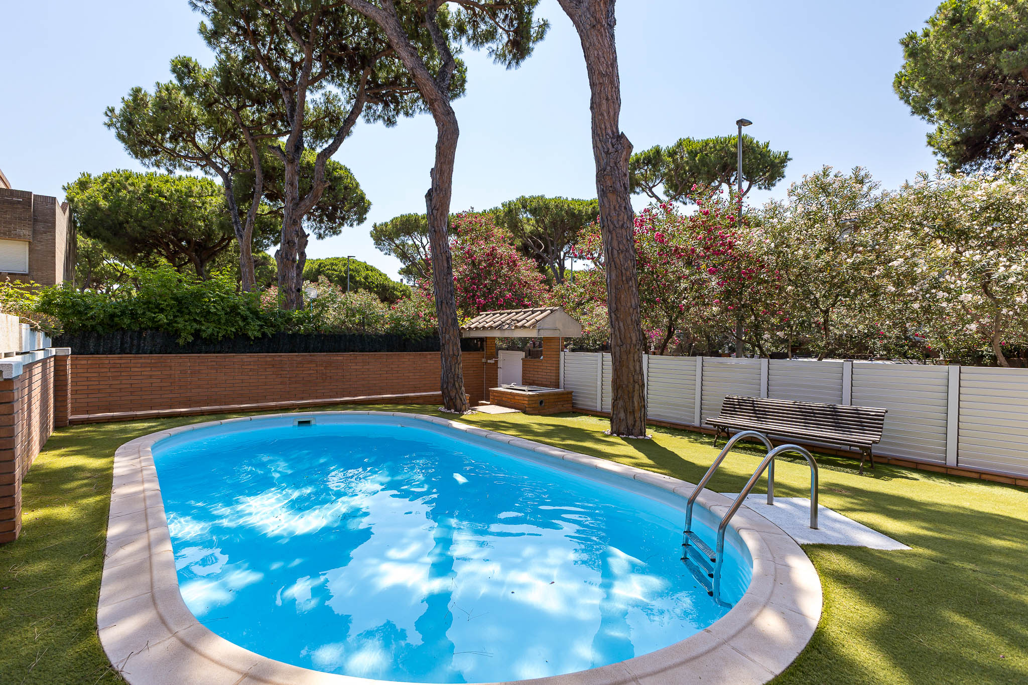 Corner house with large private garden-terrace, communal pool, and a short walk from the sea