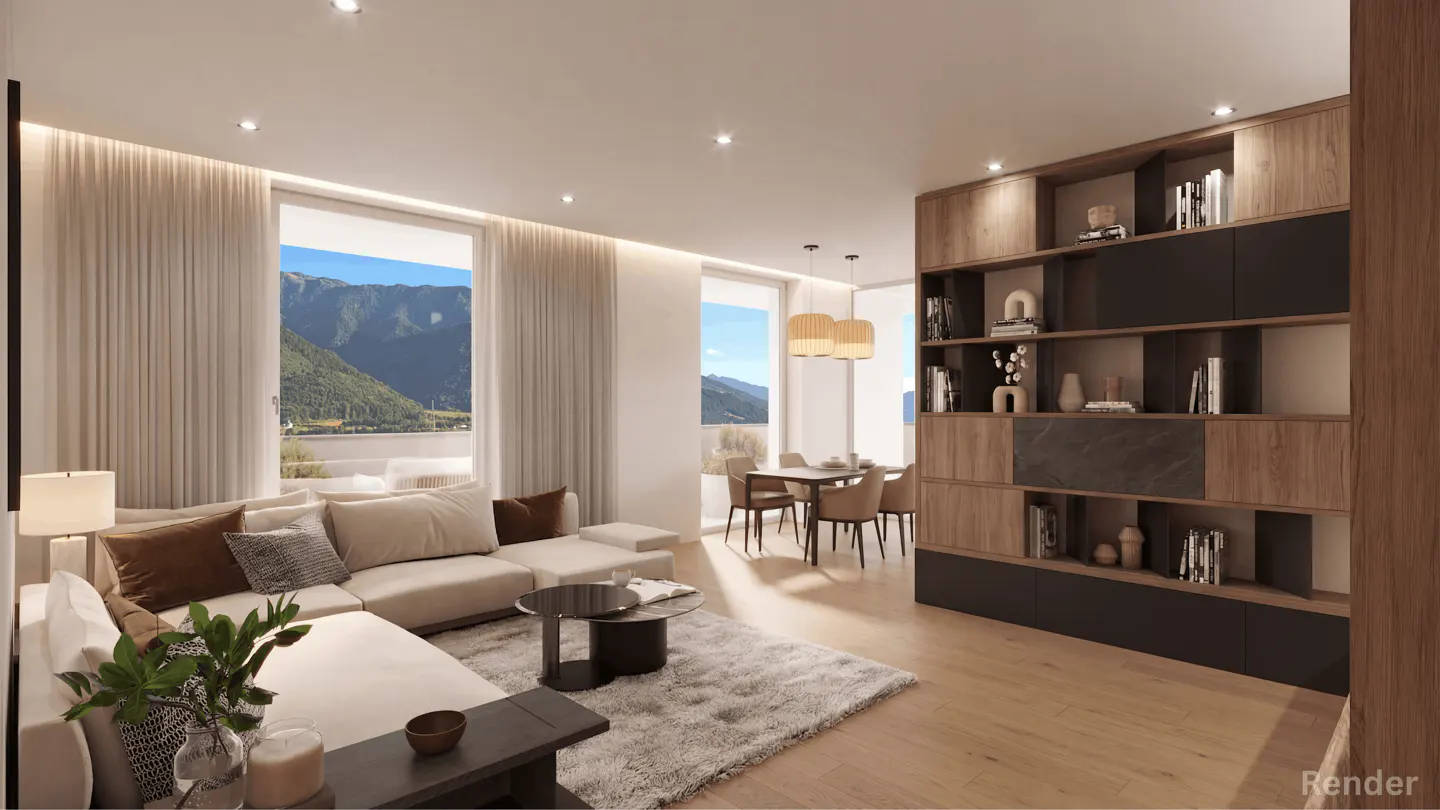 A bright, modern living room with a beige sectional sofa, a gray rug, and a wooden bookshelf. Large windows offer a view of mountains.