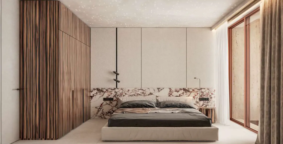 Modern bedroom with a marble headboard, gray bedding, and a wood-paneled closet. The ceiling has star-like lights. A window with curtains is on the right.