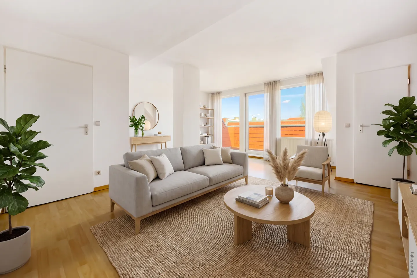 Bright living room with a gray sofa, round wood table, jute rug, and large windows with a city view. Plants add a touch of green.