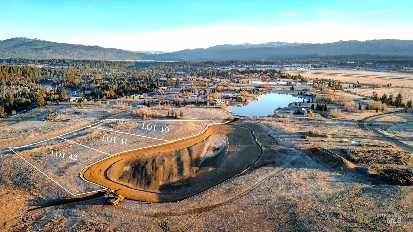 Aerial view of real estate lots 40, 41, and 42, with a lake, trees, and mountains in the background.