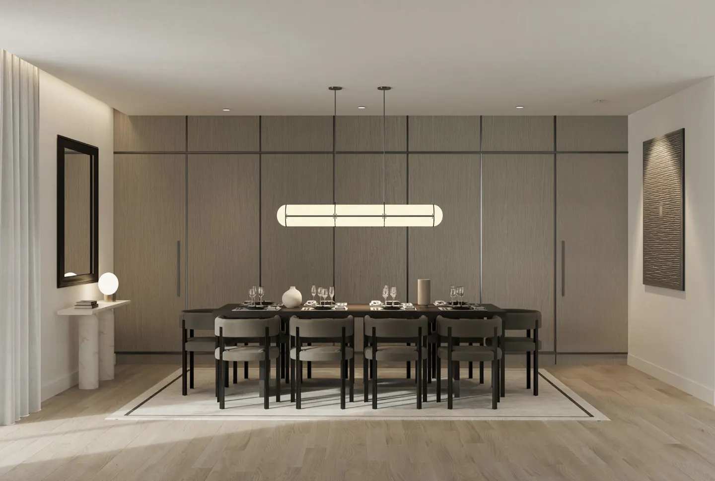 A modern dining room with a long table set for a meal, chairs, and a linear light fixture above.