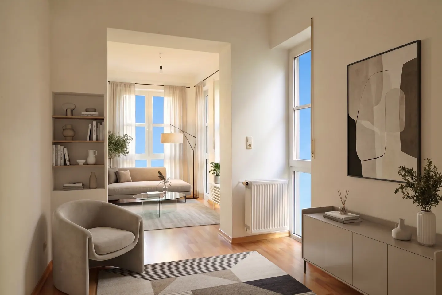 Bright, modern living room with a beige armchair, geometric rug, sideboard, and an open view into a sunlit seating area.