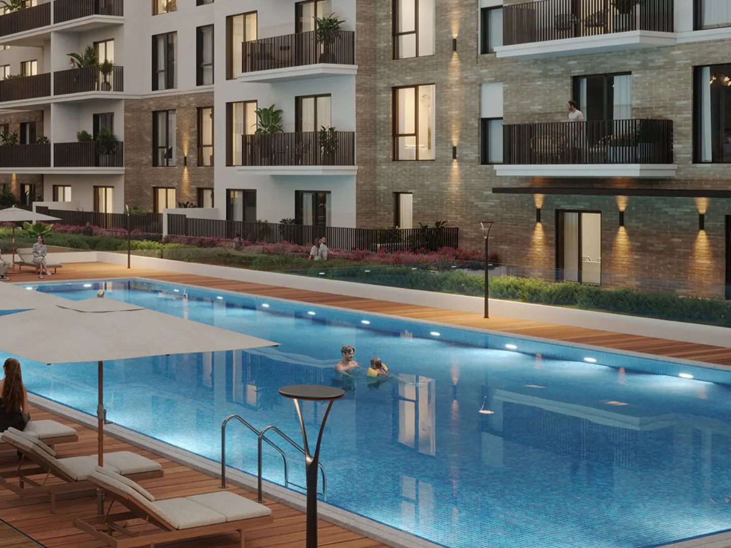 Apartment complex with a blue swimming pool, lounge chairs, and balconies. People are swimming and relaxing by the pool.