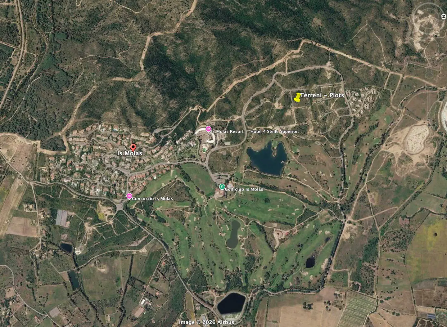 Aerial view of Is Molas, Italy, featuring a golf course, resort, plots, and surrounding green hills.