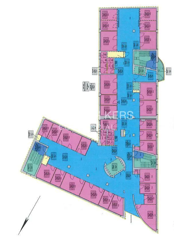Floor plan of a commercial building with pink offices, blue hallways, and green stairwells. The layout is L-shaped with a central lobby.