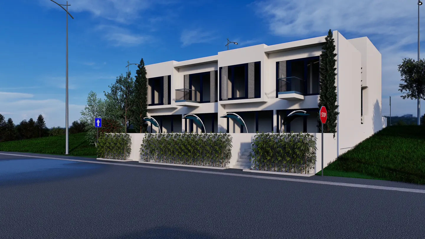 Modern white townhouses with black shutters and awnings, set behind a green hedge and a gray road under a blue sky.