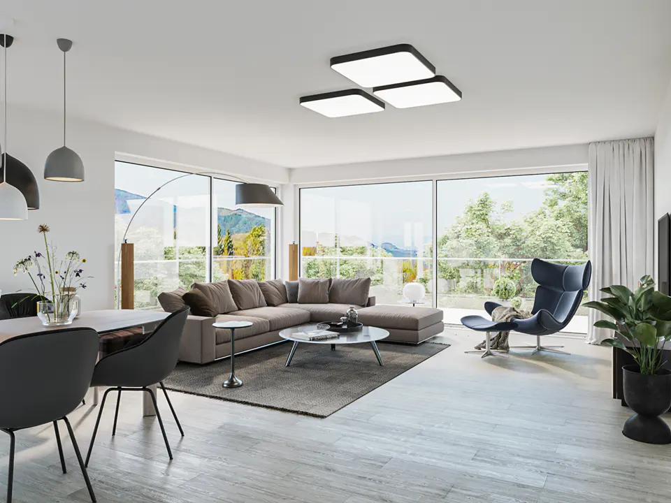 Bright, modern living room with a gray sectional sofa, blue lounge chair, and large windows overlooking a green landscape.