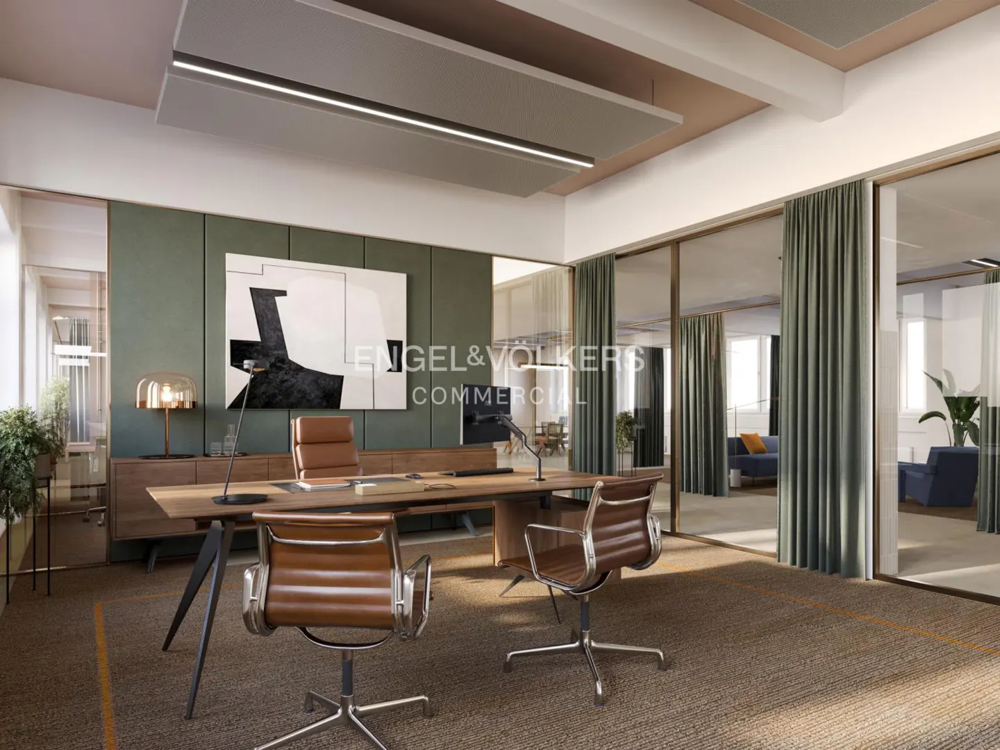 Office space with two brown leather chairs facing a long wooden desk. A black and white painting hangs on the green wall behind the desk. Glass-walled rooms are visible.