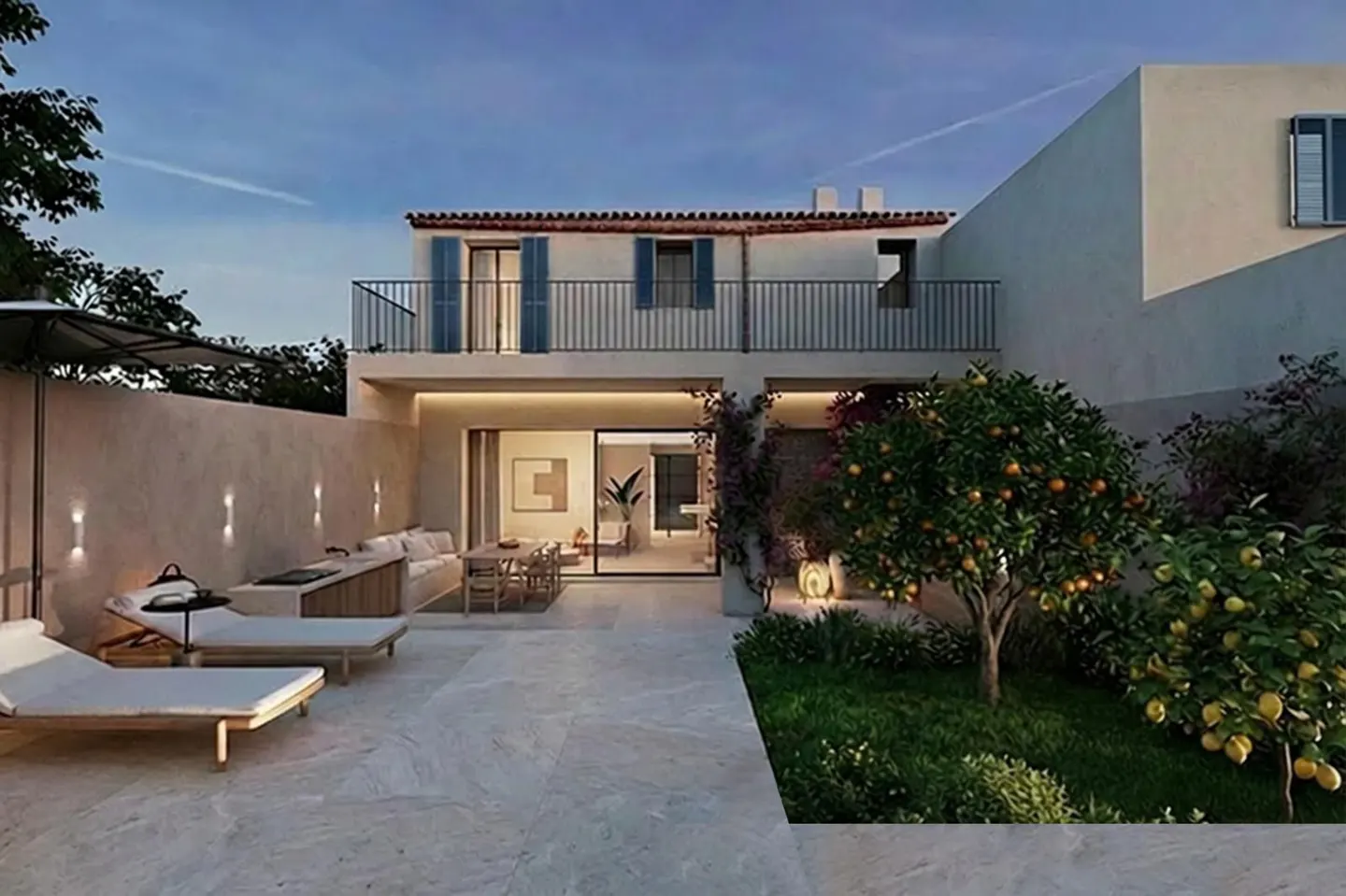 Two-story house with a balcony, blue shutters, and a patio with lounge chairs, a dining table, and an orange tree.