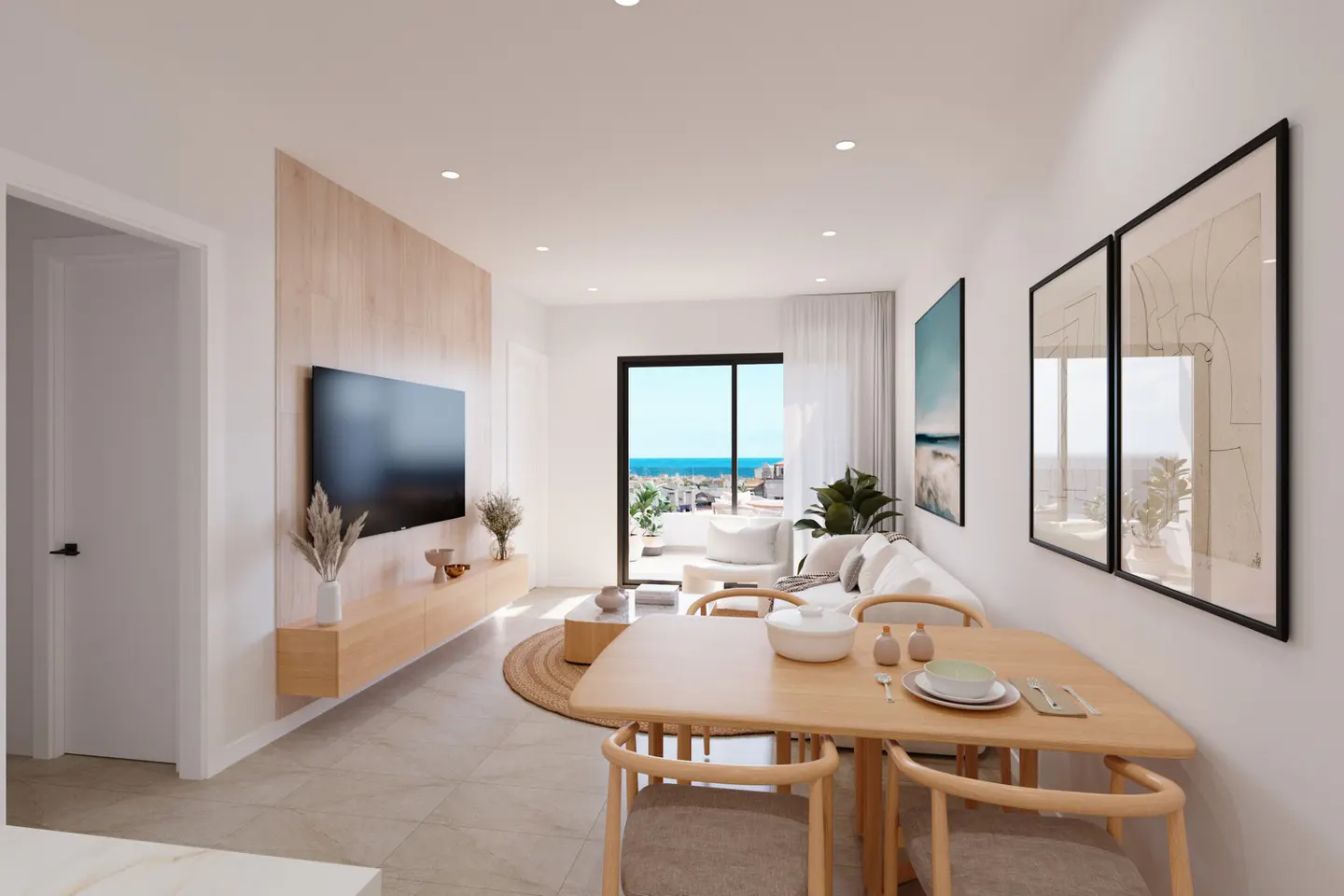 Bright living room with a dining table, TV, and a view of the ocean from the balcony. The walls are white, and the furniture is light wood.