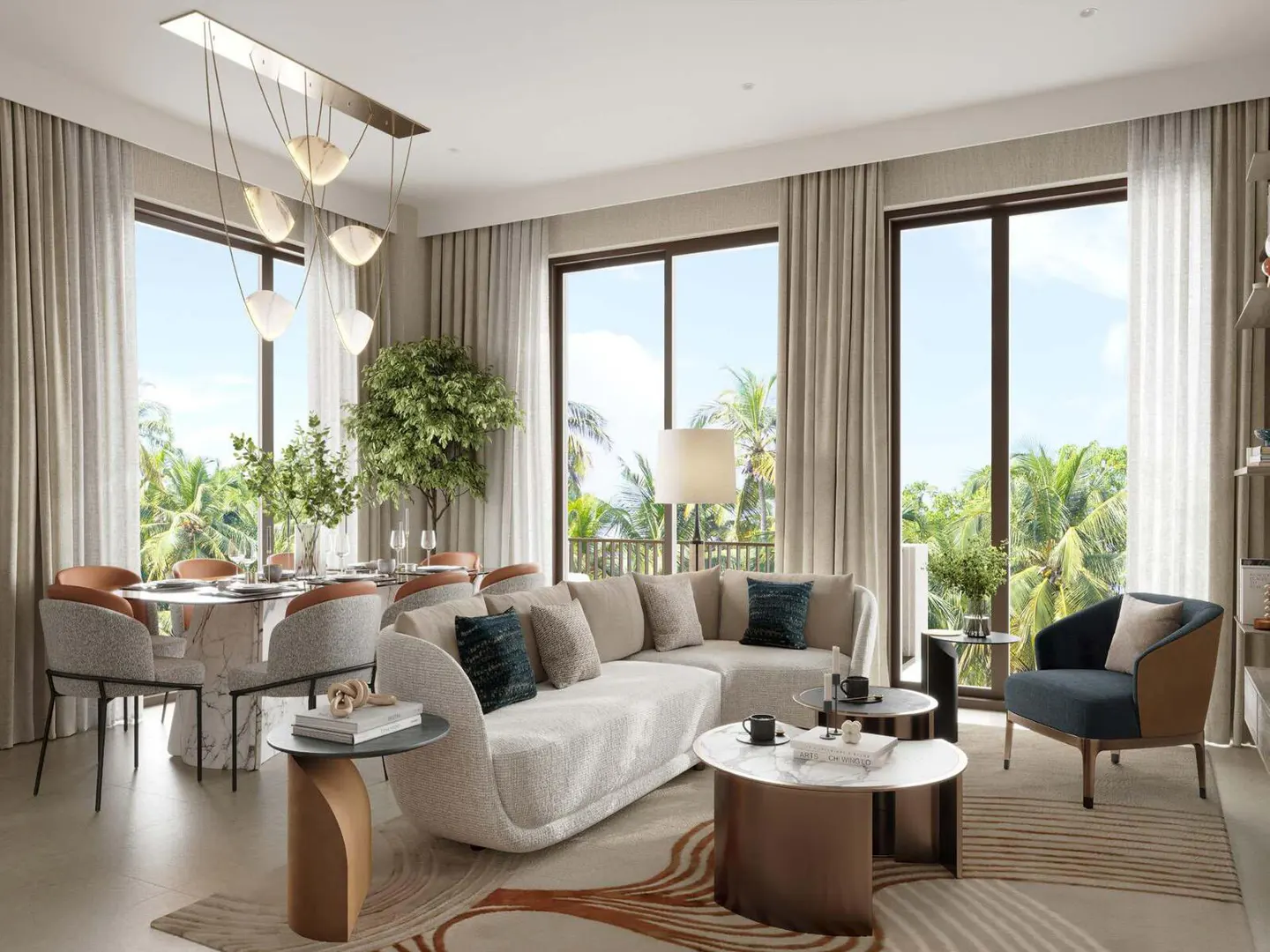 Bright, modern living room with a cream sofa, blue armchair, and round dining table. Large windows offer a view of palm trees.