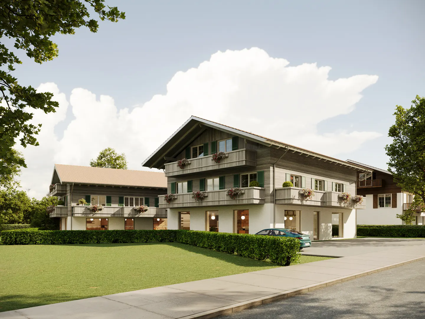 Modern alpine-style apartment buildings with wooden balconies, flower boxes, and green hedges under a bright blue sky.