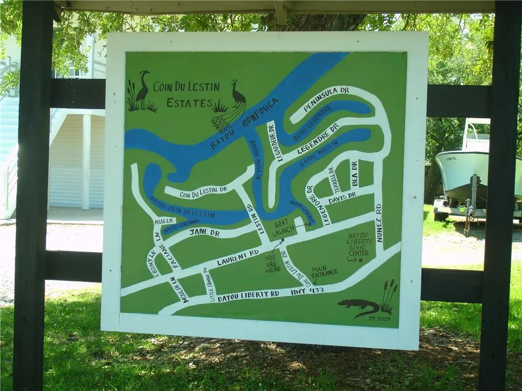 Map of Coin Du Lestin Estates, with blue bayous and green land. Roads are labeled, including Bayou Liberty Rd and Peninsula Dr.