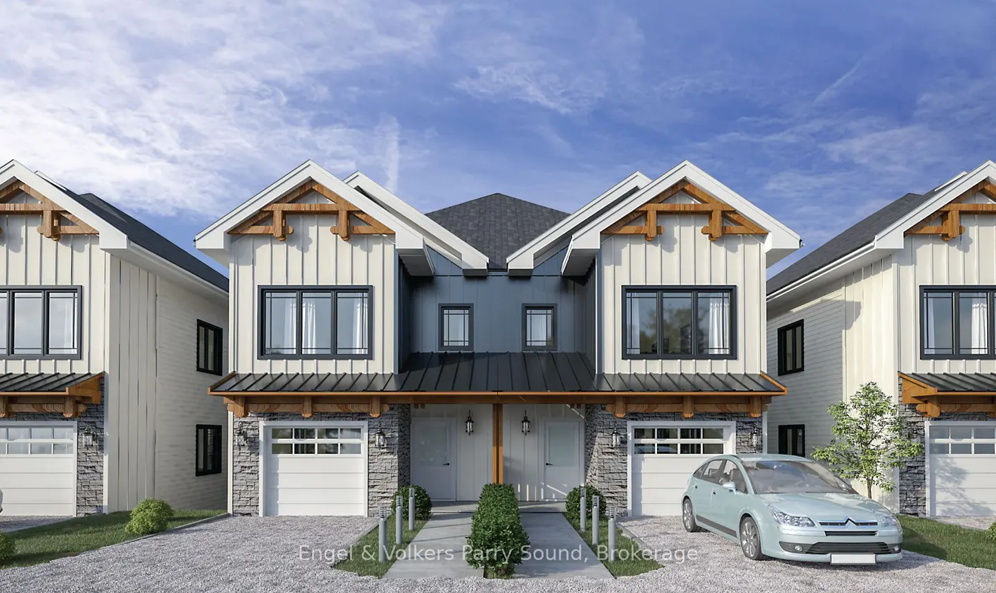 Modern townhouses with white siding, stone accents, and black trim under a blue sky. A light blue car is parked in the driveway.