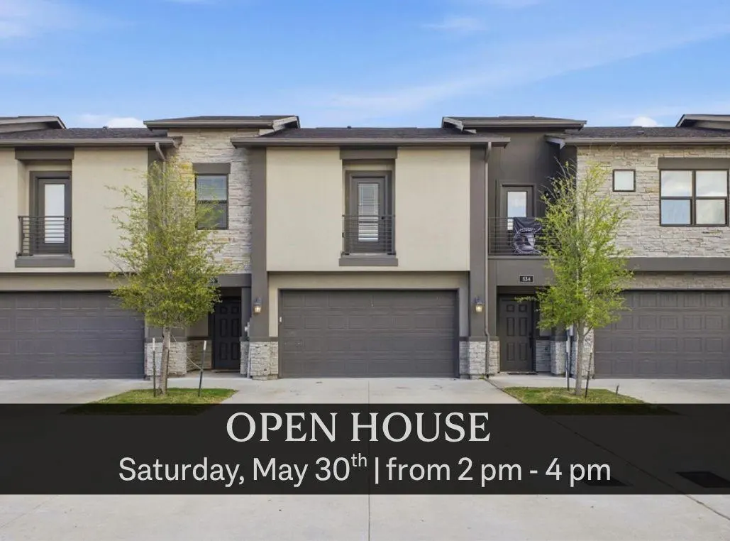 Three-story townhouses with gray garages and stone accents. Open house Saturday, May 30th, from 2-4 pm.
