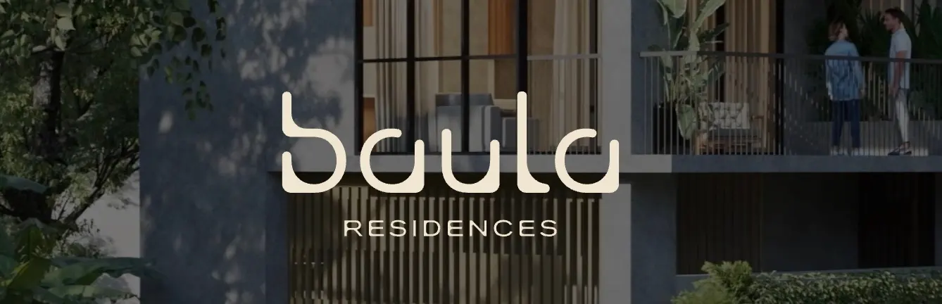 Exterior view of Saula Residences with a couple on the balcony. The building is gray with a modern design and lush greenery.