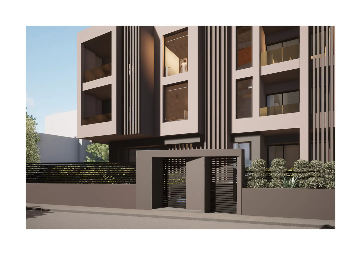 Modern apartment building with gray facade, vertical slats, and gated entrance. Balconies are visible.