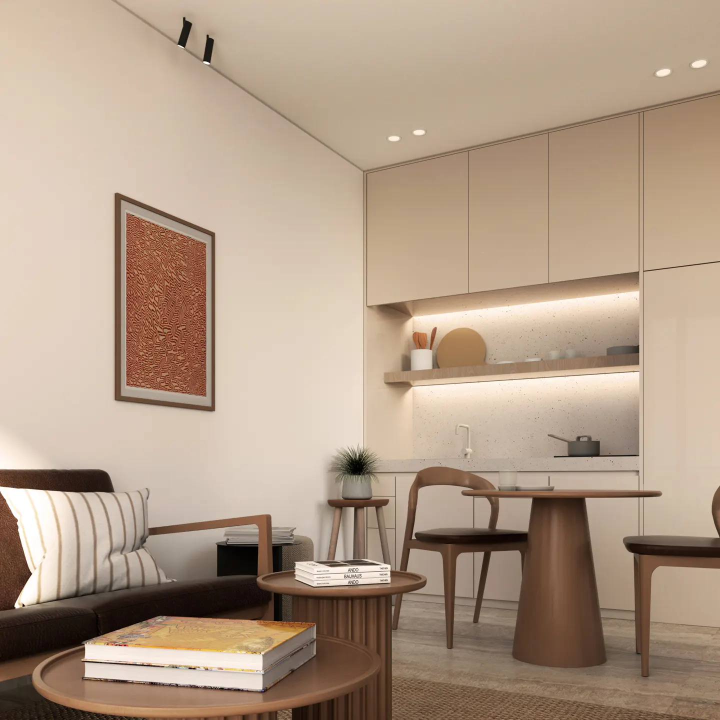 A modern living space with a brown sofa, striped pillows, and a round wooden table with books. A kitchen area is visible in the background.